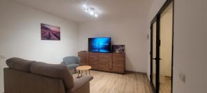 TV a/nebo společenská místnost v ubytování Sabbia Suites Casa Gloria