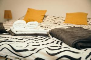 a bed with towels and pillows on it at Filip in Slavonski Brod