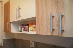 a kitchen cabinet with a shelf with food on it at Filip in Slavonski Brod