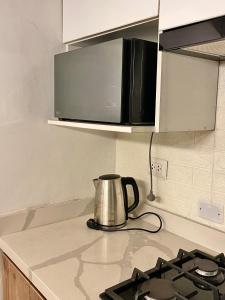 a tea kettle is sitting on a kitchen counter at Entire House close to the sea Miraflores in Lima