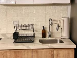 a kitchen counter with a sink and a soap dispenser at Entire House close to the sea Miraflores in Lima