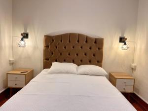 a bedroom with a large bed with two night stands at Entire House close to the sea Miraflores in Lima