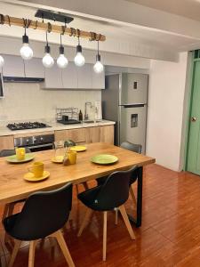 a kitchen with a wooden table and chairs at Entire House close to the sea Miraflores in Lima +40 photos