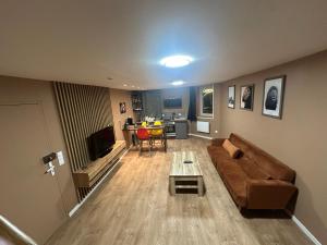 a living room with a couch and a table at EASYHOME DUNKERQUE in Dunkerque +3 photos