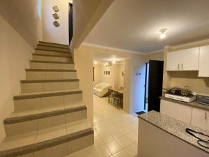 a staircase leading to a kitchen and a living room at Vistalegre2 in Portoviejo