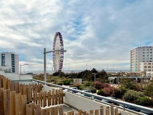 a ferris wheel in the middle of a city at Hôtel Le Littoral - Berck sur Mer in Berck-sur-Mer