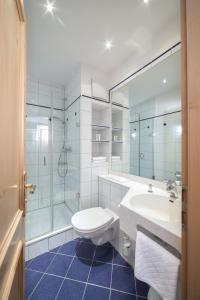 ein Bad mit einem WC, einem Waschbecken und einer Dusche in der Unterkunft Hotel Eschenhof in Kirchheim