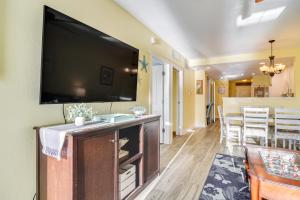 a living room with a large flat screen tv on a wall at Waterfront Condo with Water Park, Walk to the Beach! in Clearwater Beach