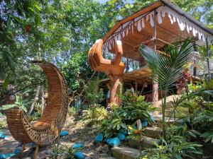 a large wooden structure in front of a house at River Glamping Melgar in Melgar