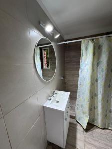 a bathroom with a sink and a mirror at Merlinda in Merlo
