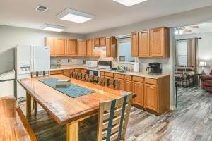 a kitchen with wooden cabinets and a wooden table at Kentucky Lake Retreat Near Marina and Launch! in Faxon