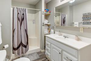 a bathroom with a sink and a shower at Kentucky Lake Retreat Near Marina and Launch! in Faxon +17 photos