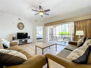 a living room with two couches and a flat screen tv at Spacious 3 Bed 3 Bath Luxury Condo 5 min from Disney in Orlando