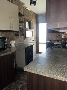 uma cozinha com um balcão de granito e um fogão em Furnished apartment - Madinaty em Madinaty