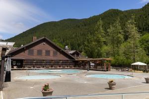 a building with two pools in front of a mountain at Sol Duc Hot Springs Resort in Ovington