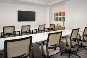 a conference room with a large white table and chairs at Element Jacksonville Beach in Jacksonville Beach +44 photos