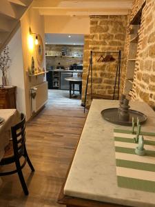 a kitchen and dining room with a table and a counter at Comme à la maison in Saint-Aubin