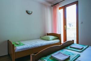 Posteľ alebo postele v izbe v ubytovaní Apartments Lovre