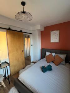 a bedroom with a bed and a table and a lamp at Lartdevivre in Ambilly