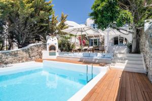 a villa with a swimming pool and a house at Zegna Pool Villa, Three Bedrooms in Mikonos