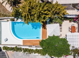 an overhead view of a swimming pool with a table and umbrella at Zegna Pool Villa, Three Bedrooms in Mikonos
