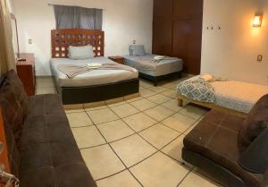 Postel nebo postele na pokoji v ubytování Hotel Colonos Los Cabos