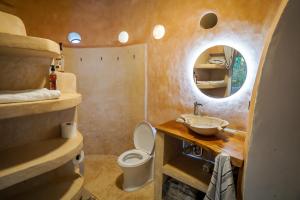a small bathroom with a toilet and a mirror at Dome @Jackfruit Jungle Paradise in Solferino 
