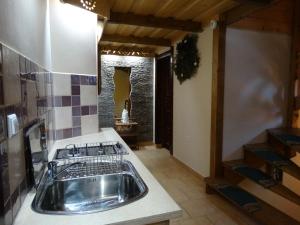 a kitchen with a sink and a stove at Wczasy Pod Giewontem in Kościelisko