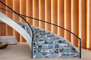a staircase in a house with a glass wall at Delta Hotels by Marriott™ Virginia Beach Waterfront Suites in Virginia Beach