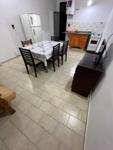 a dining room with a table and chairs in a kitchen at Las Toninas 46 ll in Las Toninas