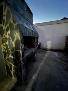 an empty room with a stone fireplace in a building at Las Toninas 46 ll in Las Toninas
