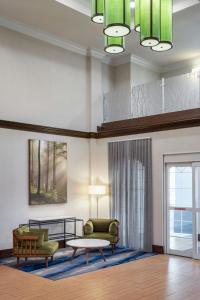 a living room with a couch and a table at Fairfield Inn & Suites by Marriott Charleston North/Ashley Phosphate in Charleston