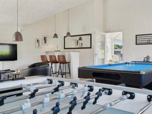 a living room with a pool table and a tv at 5 star holiday home in Sydals in Sarup