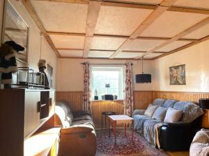 a living room with a couch and a table at 10 person holiday home in BÄCKEFORS in Bäckefors