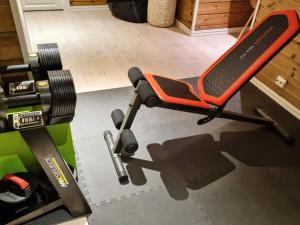 an orange chair in a room with a machine at 9 person holiday home in Rauland in Rauland