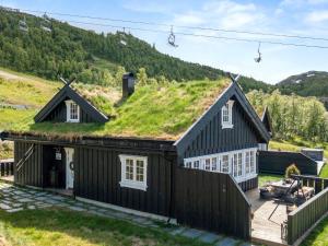 an image of a house with a grass roof at 9 person holiday home in Rauland in Rauland
