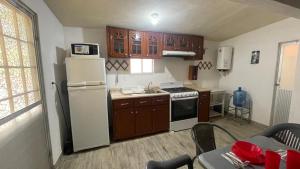 a kitchen with a white refrigerator and a stove at Villa Playa Encantada in Barra de Tuxpan
