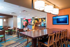 a dining room with a large wooden table and chairs at Fairfield Inn & Suites by Marriott Medina in Medina