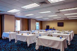 a room filled with tables and chairs with white table cloth at Fairfield Inn Charlotte Mooresville Lake Norman in Mooresville +24 photos