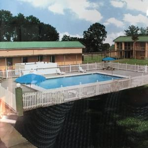 a bridge over a river with a swimming pool at Garden Inn & Suites in Pensacola
