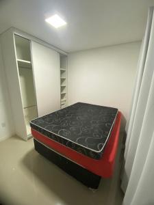 een zwart-rood matras in een kamer bij Apartamento Santa Clara in Balneário Camboriú