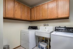a kitchen with a sink and a washing machine at Runnymeade Cottage in Kings Beach