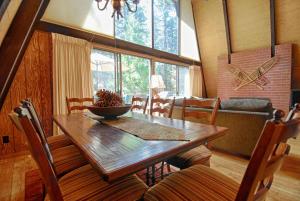 a dining room with a wooden table and chairs at Runnymeade Cottage in Kings Beach