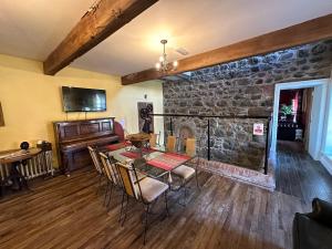a dining room with a table and a stone fireplace at The Old Flax Mill Yoga Retreat in Coleraine