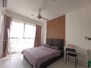 a bedroom with a bed and a desk and a window at Empire Citystay Astetica 3 Beds in Serdang +4 photos