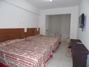 a hotel room with a bed and a desk at Atlântico Centro Apartments in Rio de Janeiro