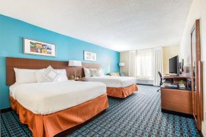 a hotel room with two beds and a flat screen tv at Fairfield Inn Charlotte Northlake in Charlotte +19 photos