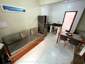 a living room with a couch and a table at Departamento 3- Pinheira in Praia de Cima (Pinheira)