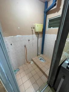 a small bathroom with a toilet in a room at Lylinz Dy Cermai in Pasir Gudang +3 photos