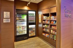 a grocery store aisle with two refrigerators and drinks at Fairfield Inn & Suites by Marriott Jeffersonville I-71 in Jeffersonville